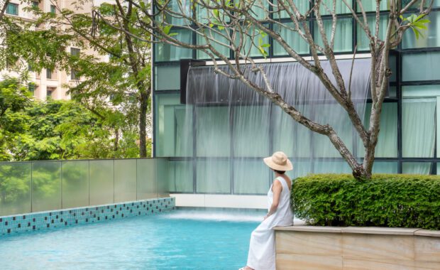 Lady Sitting By The Swimming Pool at Park Regis by Prince Singapore